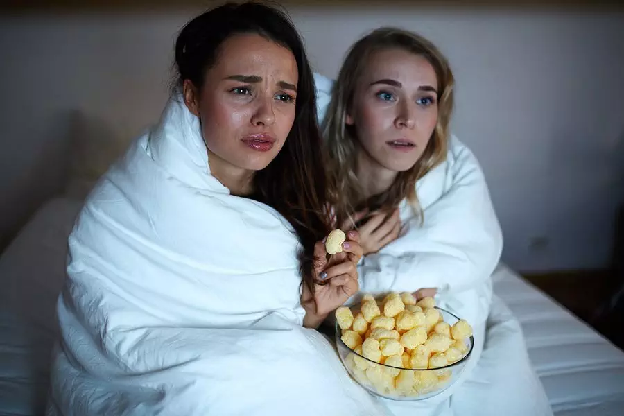 Emotional girls wrapped into blanket